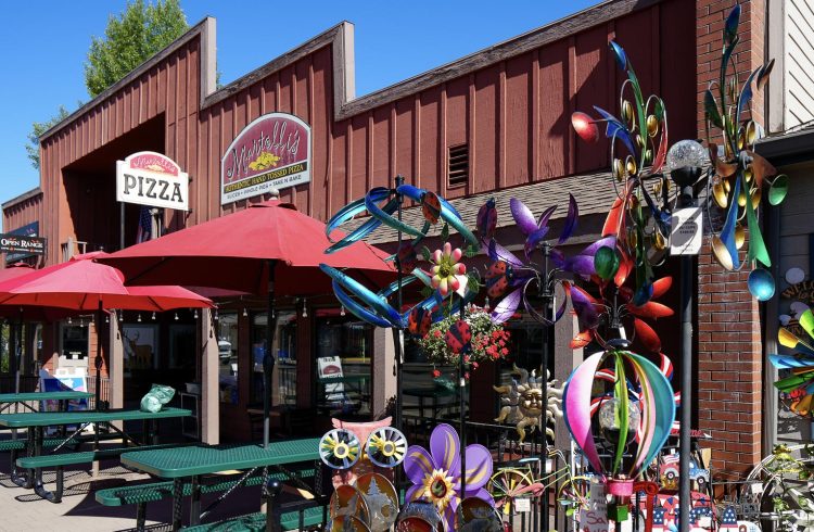 colorful yard decor with red building and outdoor seating in the background