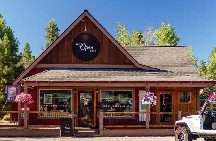 wooden restaurant building with green trees