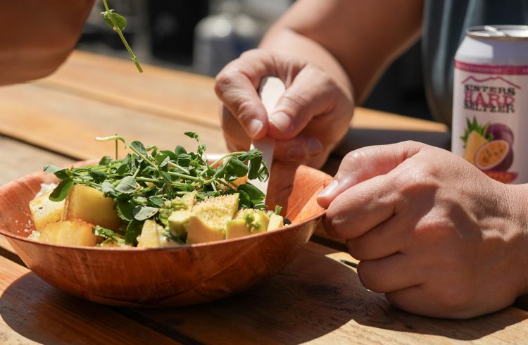 veggie bowl with sprouts at a picnic table
