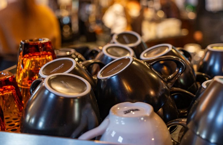 coffee mugs atop an espresso machine