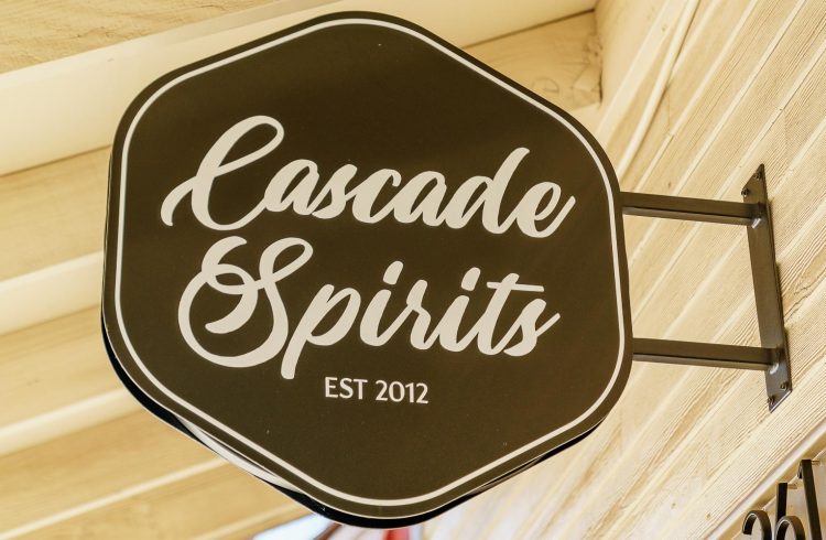 cascade spirits sign attached to the exterior of building