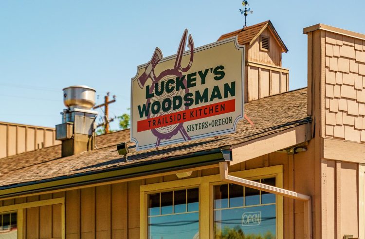 luckey's woodsman sign on a tan building with blue sky in the background