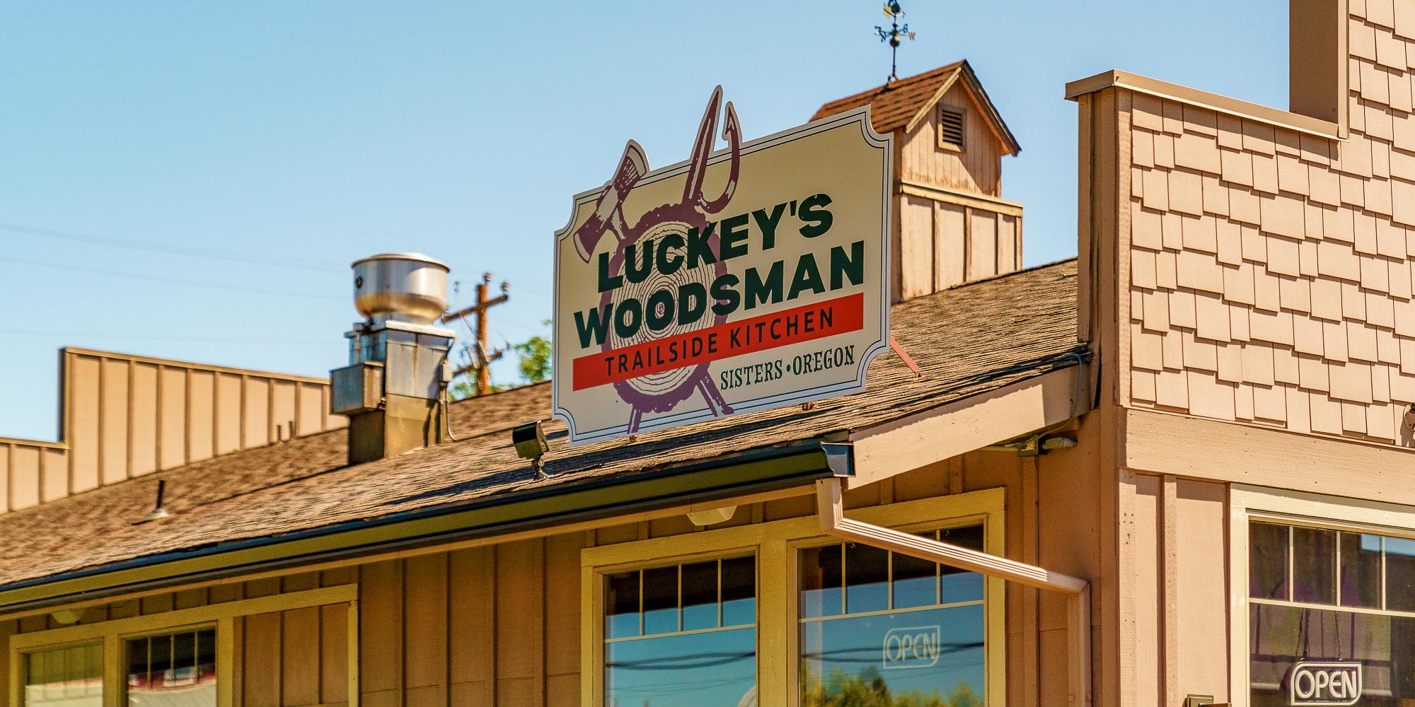 luckey's woodsman sign on a tan building with blue sky in the background