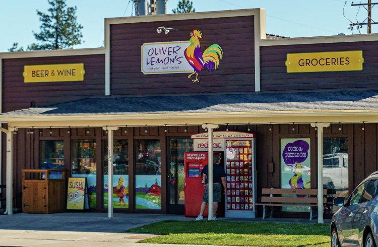 Oliver lemon's grocery store with signage and red box at the entrance