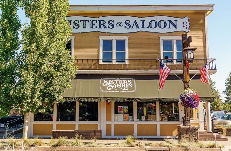 exterior of sisters saloon with awning and American flag