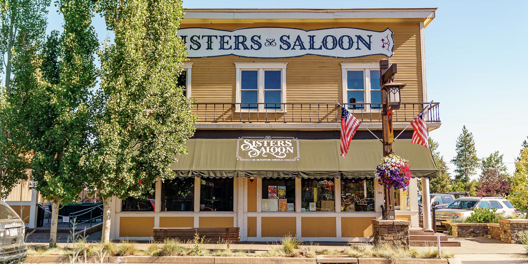 exterior of sisters saloon with awning and American flag