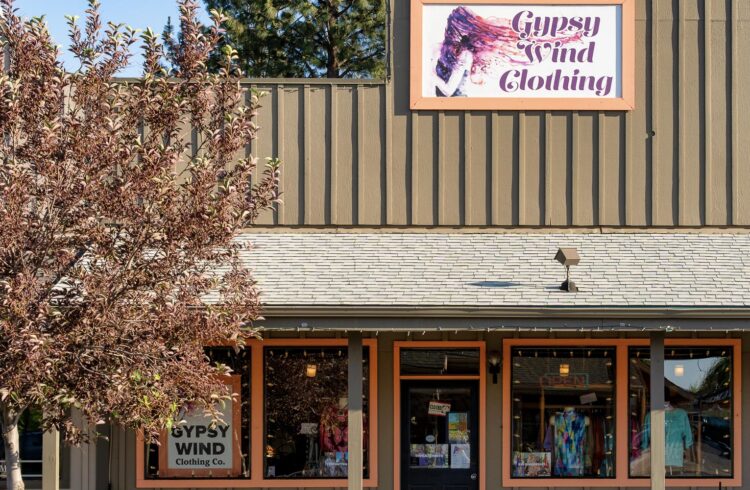 clothing store exterior with tree in foreground