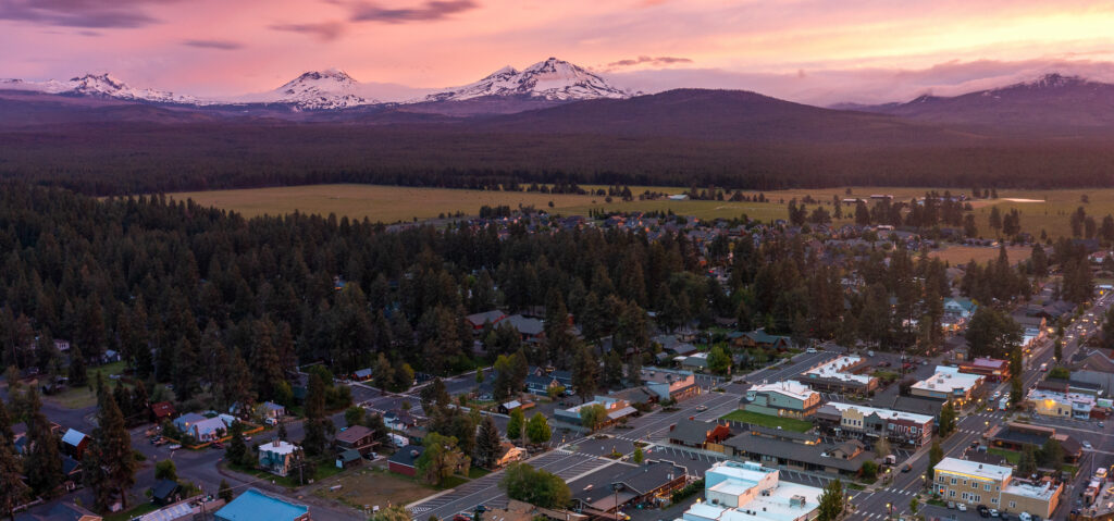 sunset aerial photo of sisters Oregon with snowy mountains