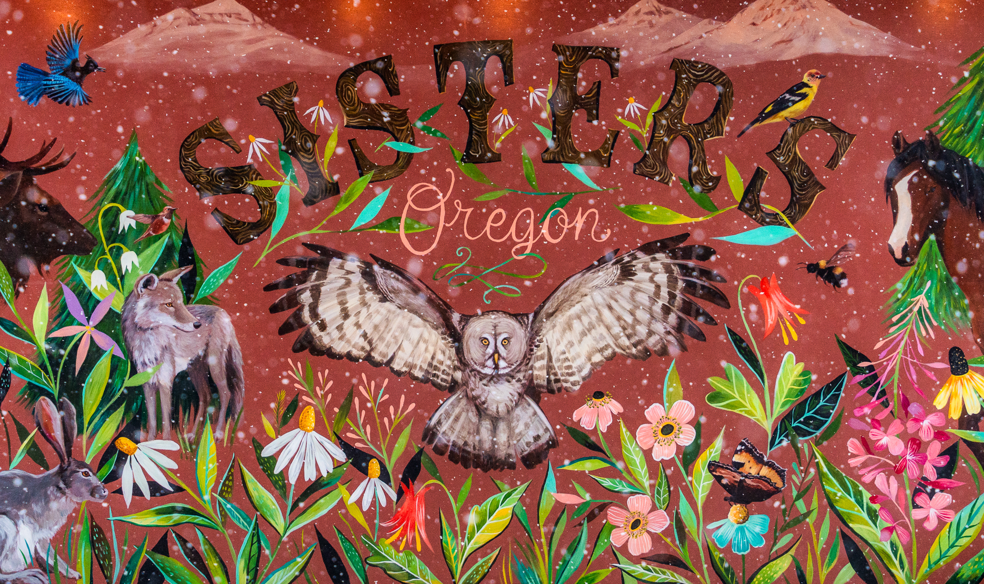 sisters Oregon mural with colorful flora and fauna