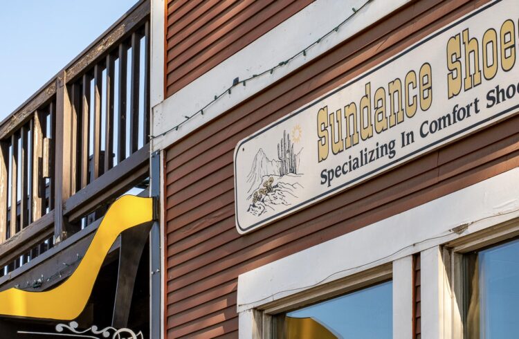 shoe store exterior with yellow high-heel sign