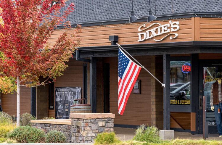 western clothing shop with American flag and maple tree in the front