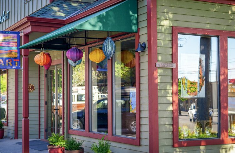 green building with colorful lanterns hanging