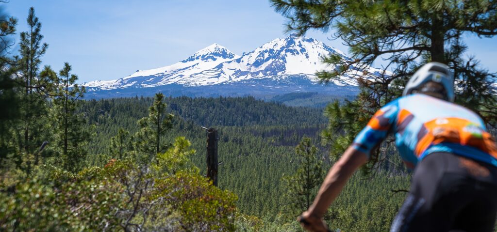 mountain biker with mountains in the distance