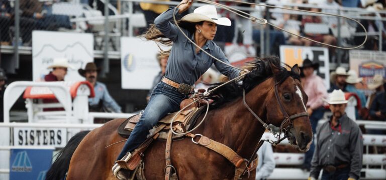 Woman with lasso riding horse at the Sisters Rodeo
