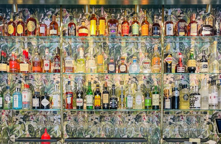 liquor lining a wallpapered wall