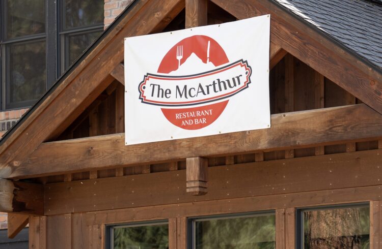 red and white sign on a wood restaurant entrance