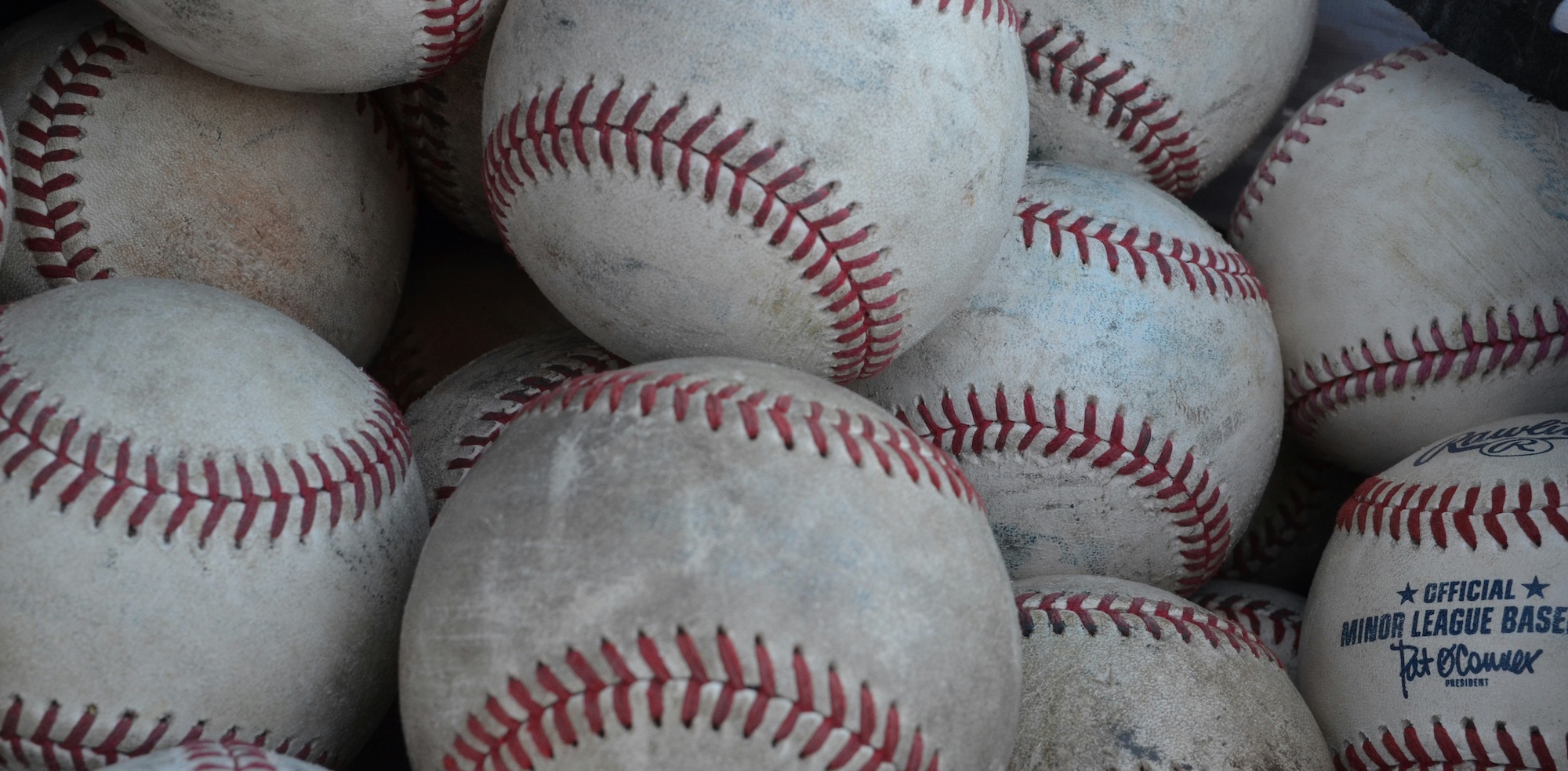 pile of used baseballs